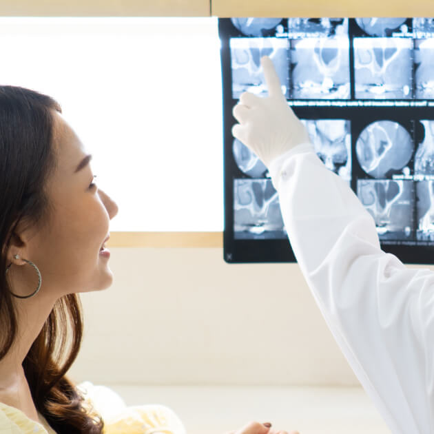 dentist showing patient a series of X-rays